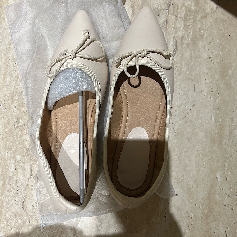 beige pointed ballet flats with bow and spiked heels